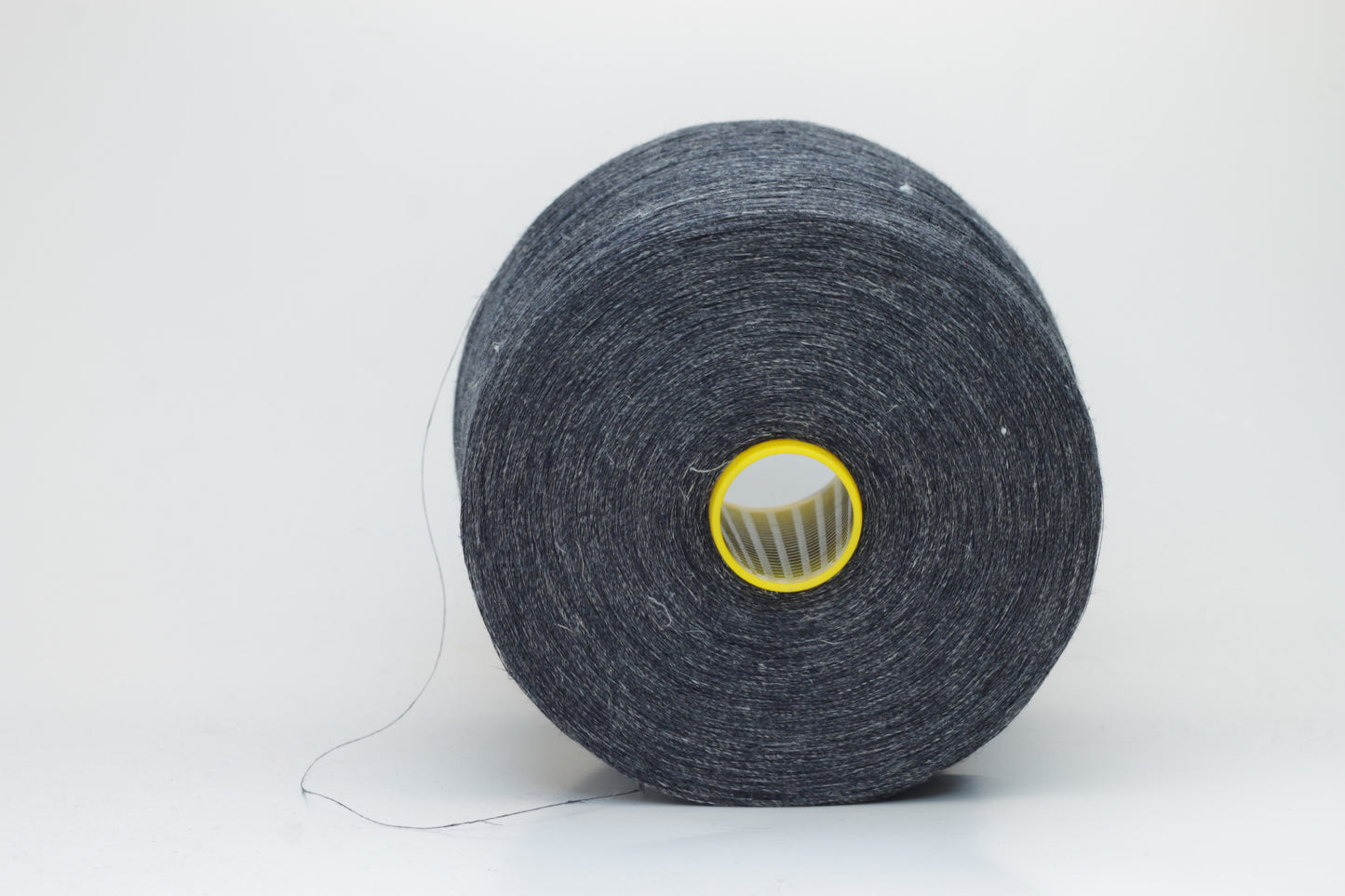 Fine, single-ply linen yarn in a rich Storm Gray. Reveals a crisp texture and subtle natural sheen, typical of pure linen fiber.