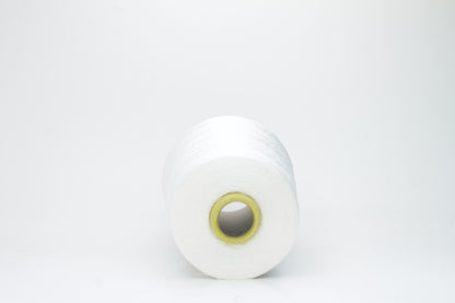 A close-up of premium 100% silk yarn, tightly plied, displaying a smooth, lustrous surface and a warm, creamy latte beige color.