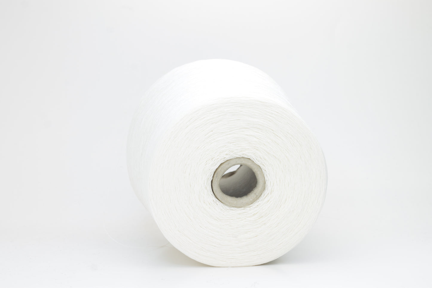 A soft white three-ply linen yarn, tightly twisted with a subtle natural sheen, presented in a neatly wound skein, showcasing its crisp, cool texture.