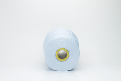 Close-up of radiant Azzurro blue silk yarn, featuring a finely spun, lustrous organzino thread with a pronounced, smooth sheen.