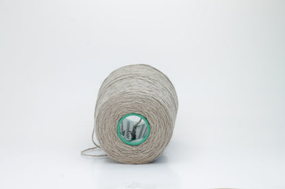A finely spun, single-ply cashmere yarn in a rich, warm squirrel-brown, exhibiting a delicate halo of soft fibers and a subtle, natural sheen.
