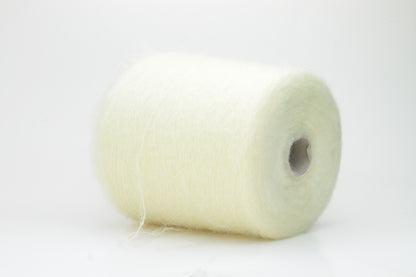 Close-up shot of SuperKidMohair yarn in Light Yellow, revealing a lustrous, fluffy texture with subtle sheen and a tight, well-defined ply twist.
