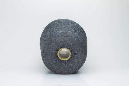 Close-up of a finely spun, lustrous dark gray silk yarn, exhibiting a smooth surface and a subtle sheen. The tightly twisted plies are visible, creating a refined, consistent thread structure.