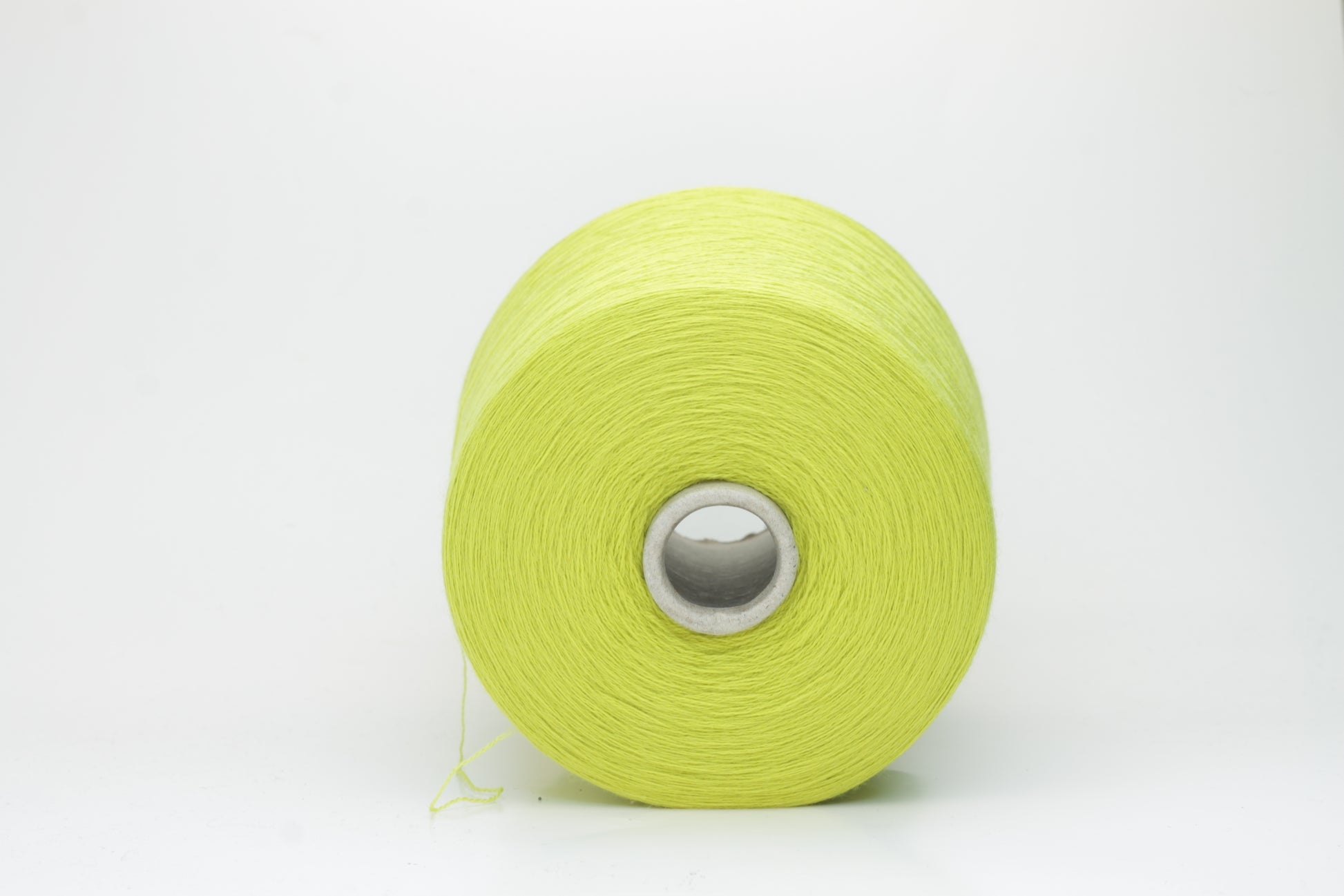 Close-up of luxurious Lime Merino wool yarn, two-ply twist with a soft, subtle sheen, and fine, consistent thread structure.