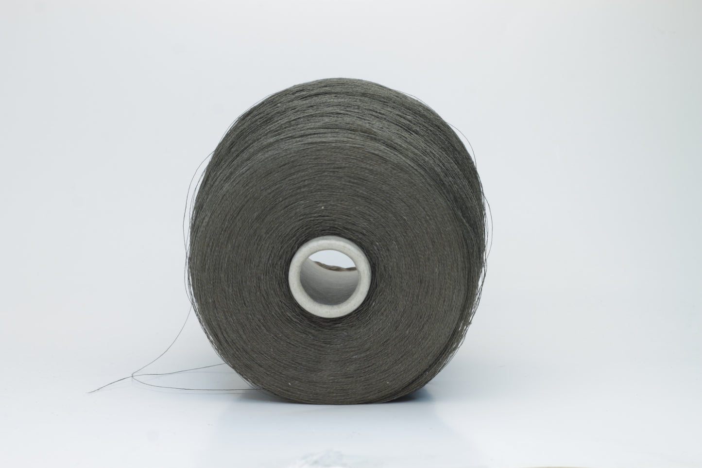 Skein of finely spun yarn, a muted artichoke green. Its smooth, even twist reveals the crisp texture of linen with a subtle, natural sheen. Low fluff, clean look.