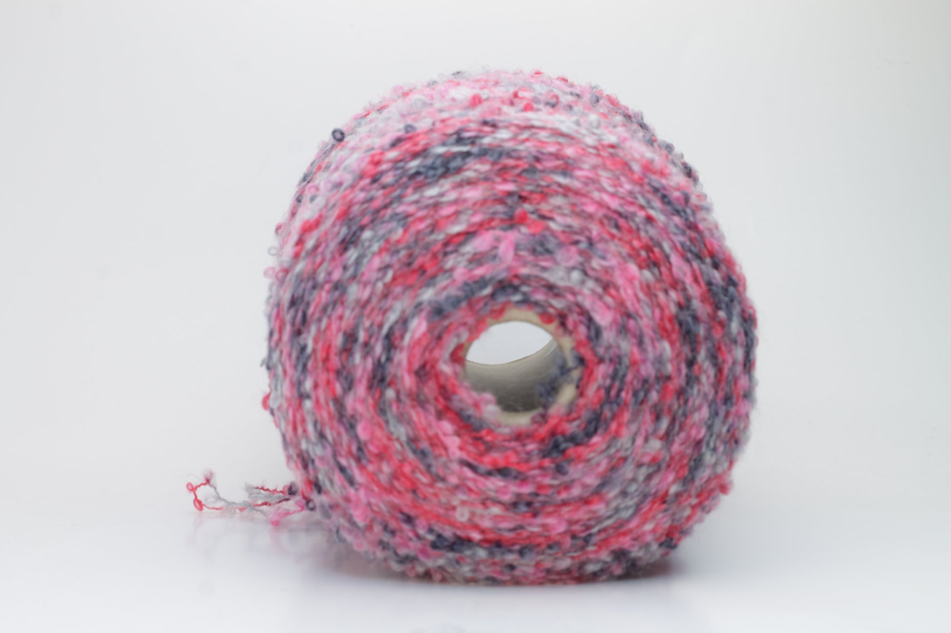 Close-up shot of multicolored SuperKidMohair yarn, showcasing its fluffy texture, slight sheen, and tight ply twist – a rich blend ready for knitting or weaving.