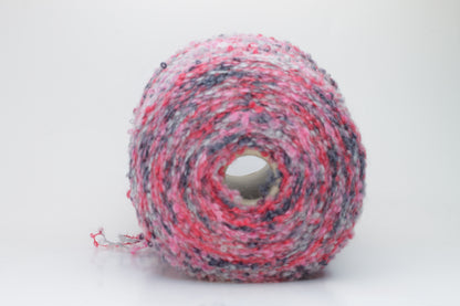 Close-up shot of multicolored SuperKidMohair yarn, showcasing its fluffy texture, slight sheen, and tight ply twist – a rich blend ready for knitting or weaving.