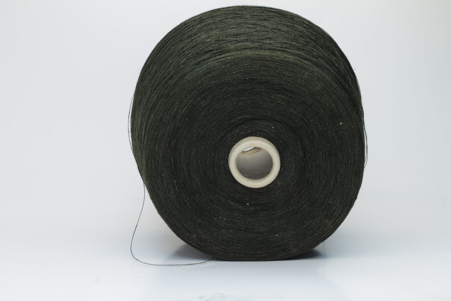 Two plies of earthy Cicoria brown linen yarn, tightly twisted with visible fibers, showcasing natural slubs and a subtle, sophisticated sheen.