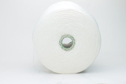 Close-up of a pristine white, two-ply cashmere yarn ball, subtly glowing with a luxurious, fine-fibered halo.