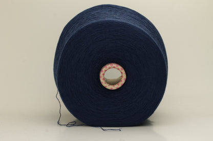Close-up of a luxurious, soft dark blue 2-ply cashmere yarn, subtly twisted with a delicate sheen and rich, deep color saturation.