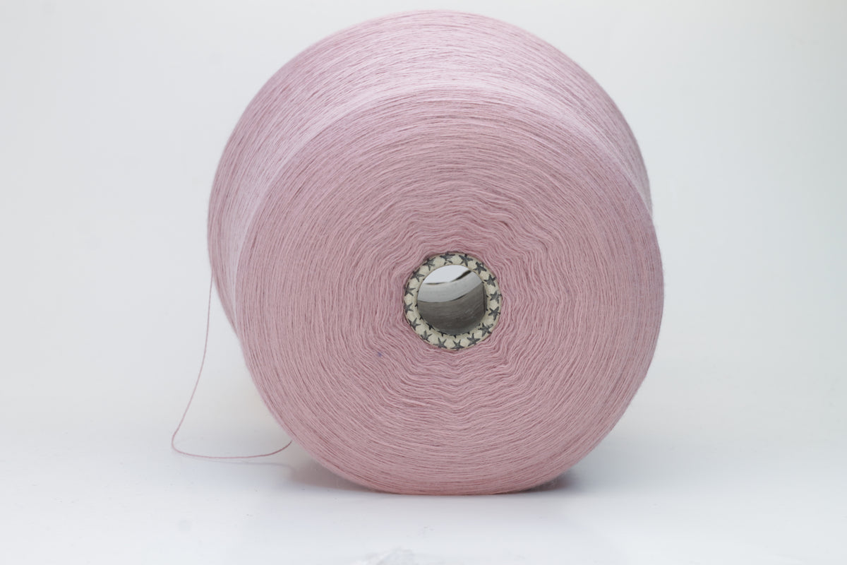 Close-up studio shot showcasing the 'Harmony 2' merino yarn in a rich 'Rosa' hue. The yarn exhibits a tight, twisted ply with an even thread structure, creating subtle sheen and a fluffy texture.