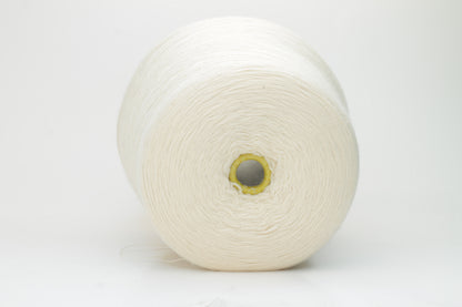 Close-up view of Zegna Baruffa Merino 100% Cashwool yarn in Milk Color. The yarn features a tight, even ply twist with visible thread structure, creating a subtle sheen and fluffy texture – perfect for intricate knitting designs.