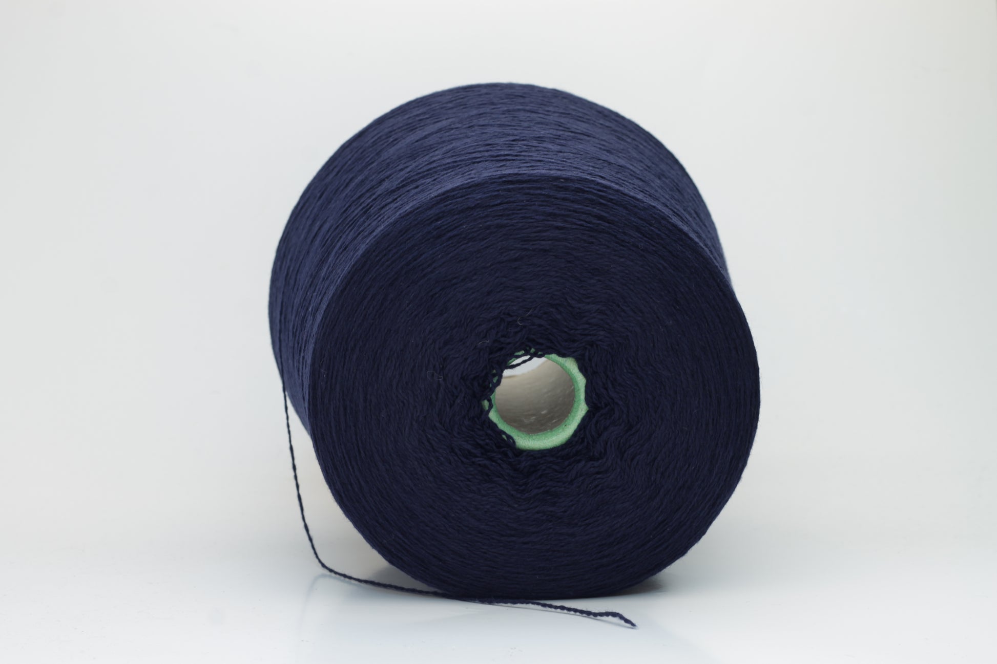 Luxurious Navy cashmere yarn, two-ply twist with a subtle sheen, displaying deep, consistent color and a fine, soft texture ready for crafting.