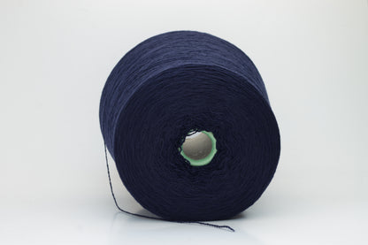 Luxurious Navy cashmere yarn, two-ply twist with a subtle sheen, displaying deep, consistent color and a fine, soft texture ready for crafting.