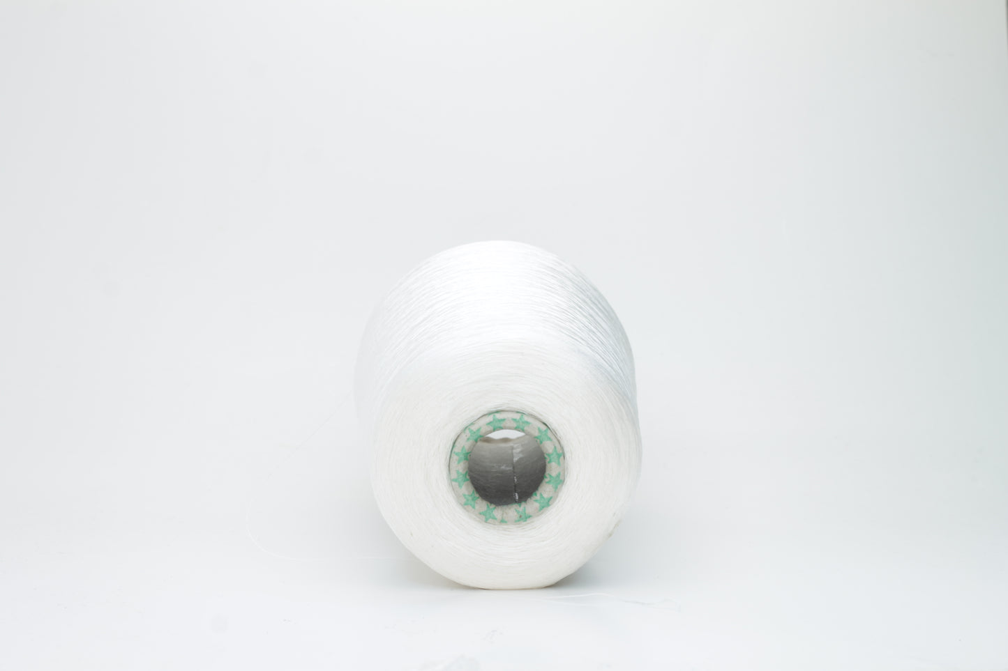 Close-up of brilliant white 100% silk yarn, single-ply strand with a smooth, highly lustrous surface, softly draped. Shimmering.