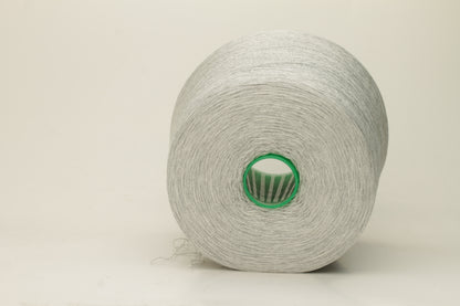 Close-up of a smooth, tightly plied gray yarn skein with a subtle, refined sheen, showcasing the luxurious blend of silk and cotton fibers.