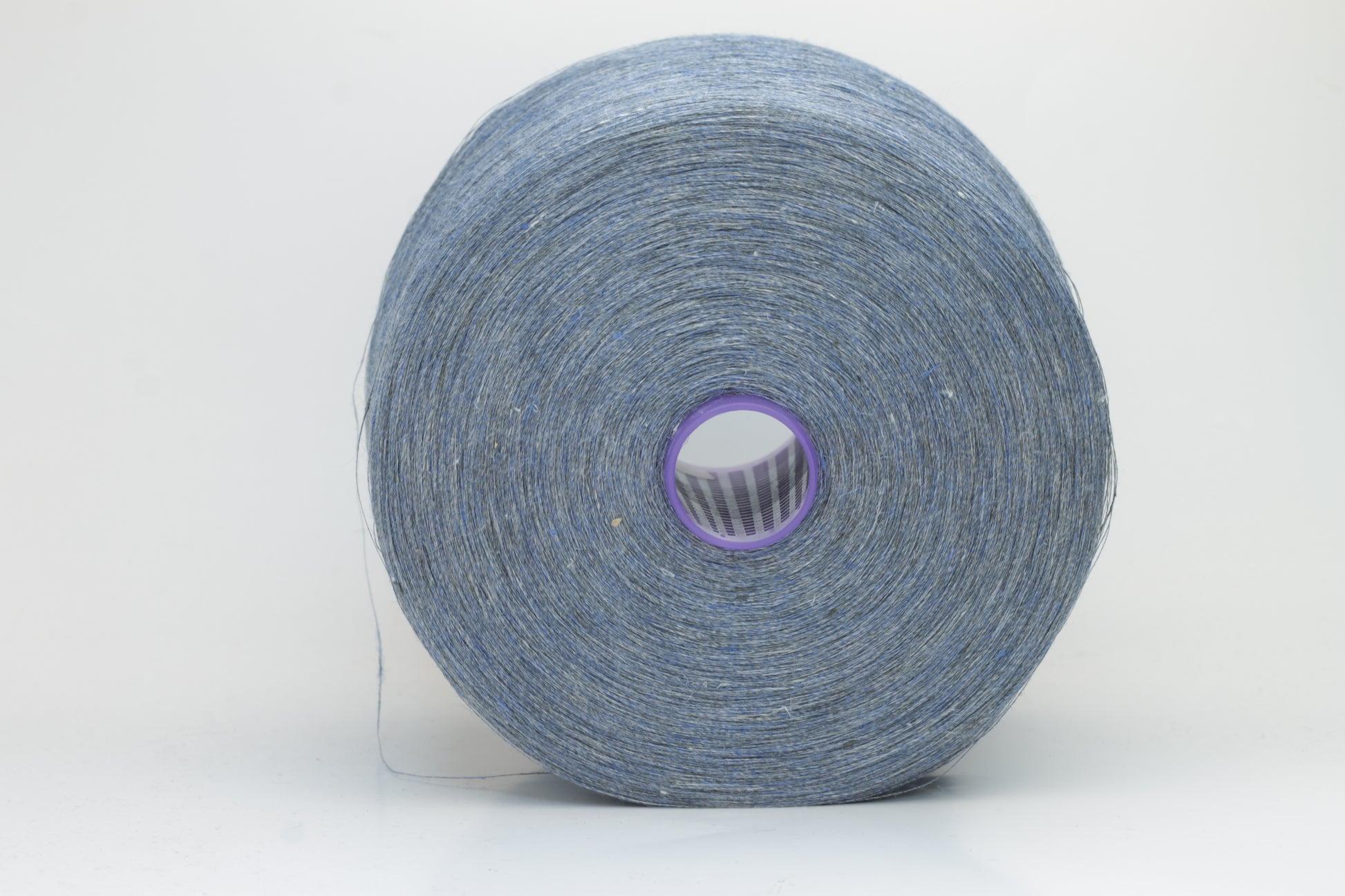 Fine, single-ply linen yarn in a rich Denim. Reveals a crisp texture and subtle natural sheen, typical of pure linen fiber.