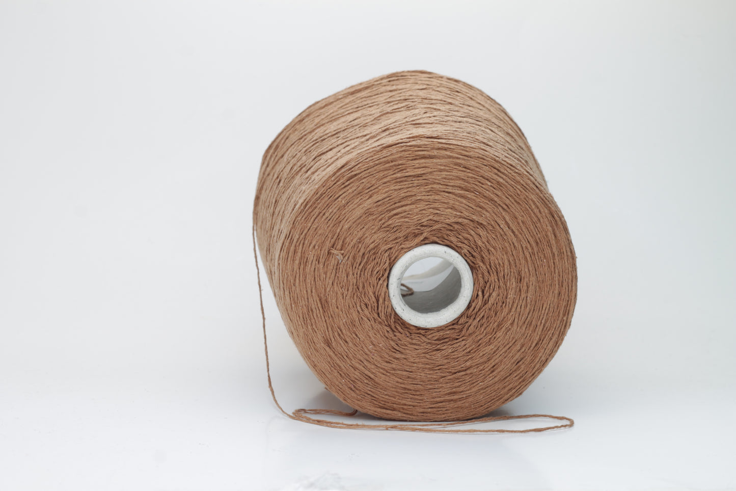 Close-up shot of luxurious Silk Bourette 100% Yarn in Mousse color. The yarn features a delicate, fine ply twist with an exceptionally smooth texture and subtle sheen, showcasing its fluffy softness.