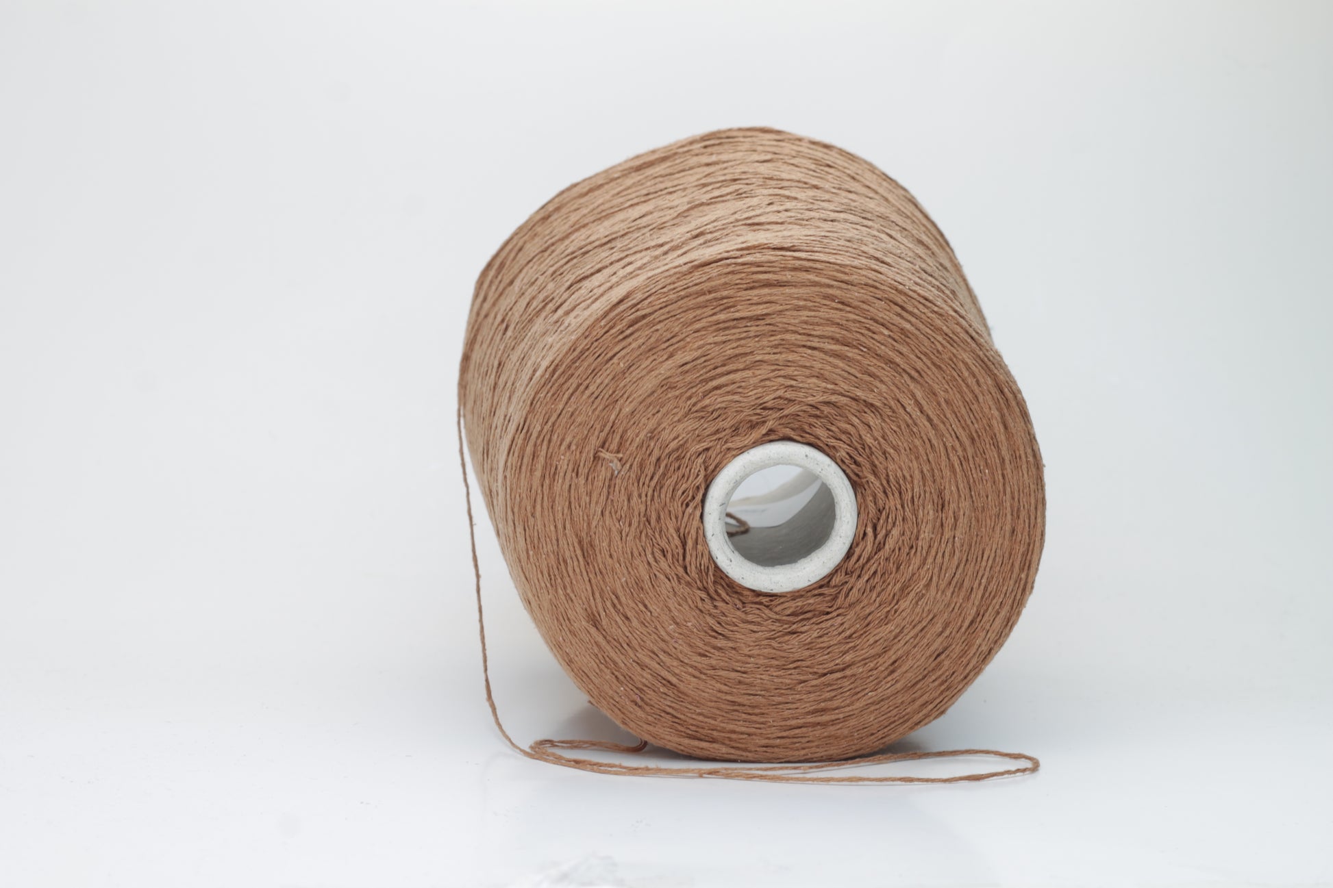 Close-up shot of luxurious Silk Bourette 100% Yarn in Mousse color. The yarn features a delicate, fine ply twist with an exceptionally smooth texture and subtle sheen, showcasing its fluffy softness.