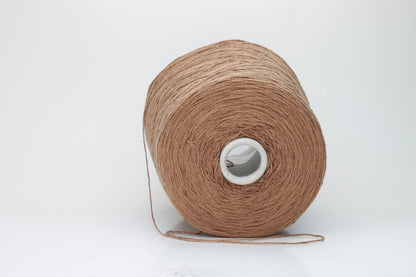 Close-up shot of luxurious Silk Bourette 100% Yarn in Mousse color. The yarn features a delicate, fine ply twist with an exceptionally smooth texture and subtle sheen, showcasing its fluffy softness.