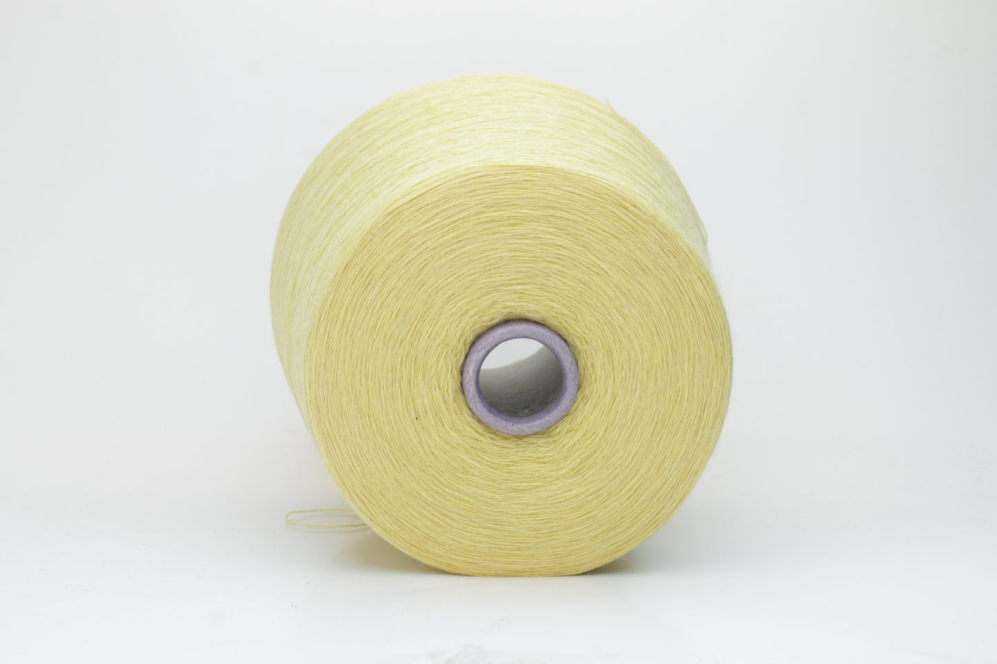Close-up image of a vibrant yellow ZEGNA Baruffa merino yarn skein, showcasing its fine ply twist and dense thread structure with subtle sheen and inviting fluffiness.