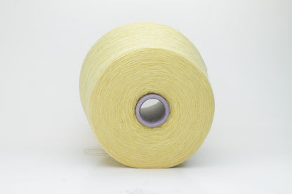 Close-up image of a vibrant yellow ZEGNA Baruffa merino yarn skein, showcasing its fine ply twist and dense thread structure with subtle sheen and inviting fluffiness.