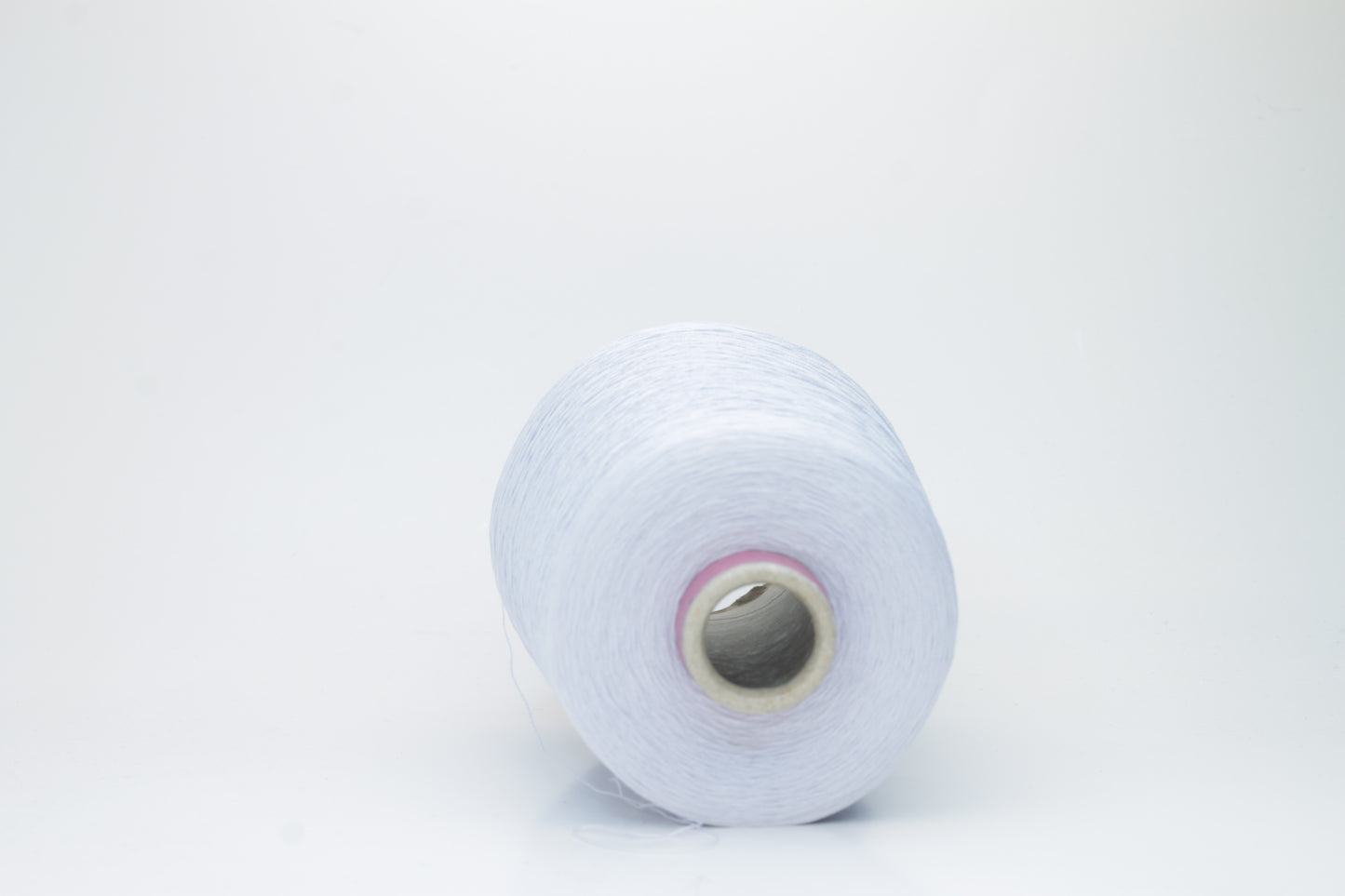 Close-up shot of light blue mulberry silk and viscose yarn, showing a tight, even ply twist with subtle sheen and fluffy texture.