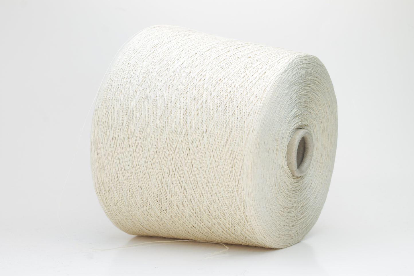 A soft light beige three-ply linen yarn, tightly twisted with a subtle natural sheen, presented in a neatly wound skein, showcasing its crisp, cool texture.