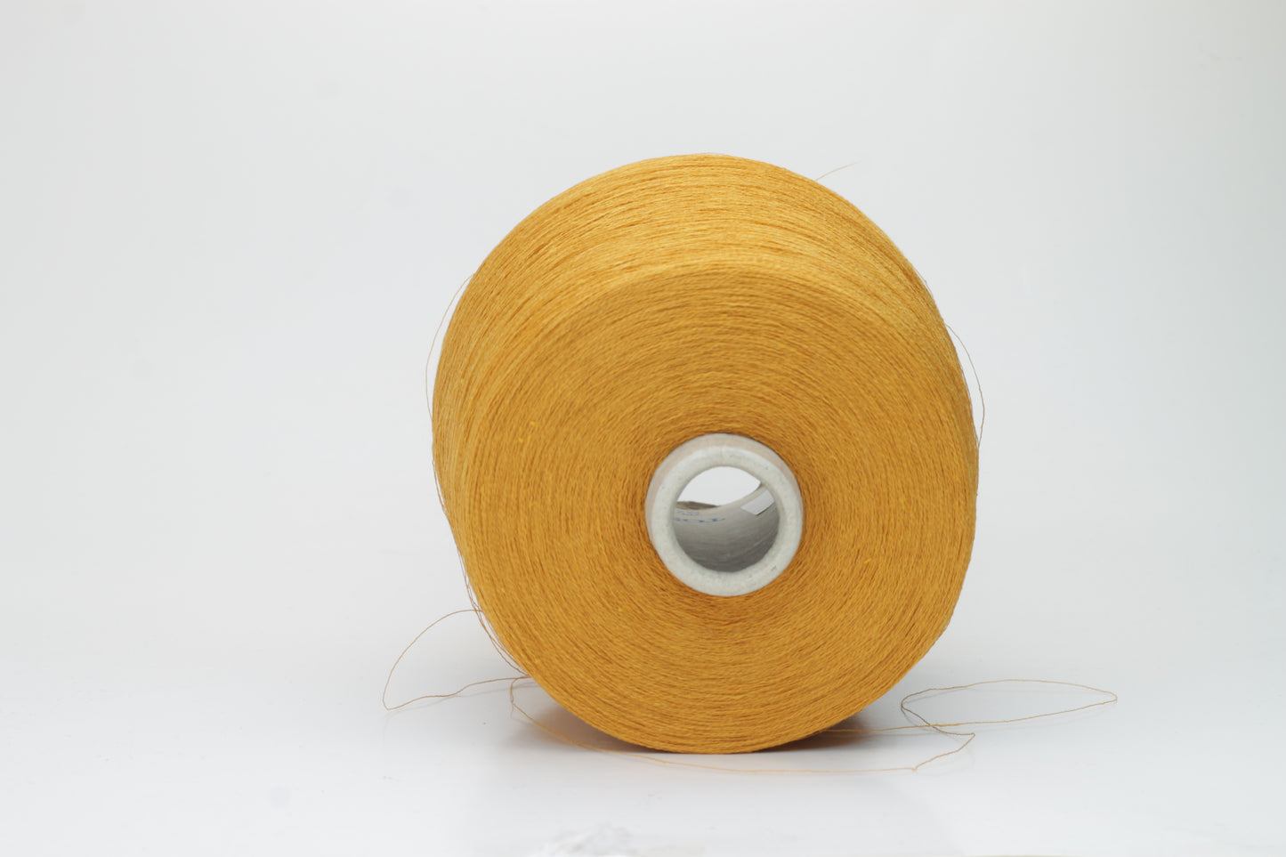 Close-up of a finely spun, vibrant orange yarn with a subtle, natural sheen. Its multi-filament structure shows a delicate twist, offering both crispness and soft resilience, suitable for textile artistry.
