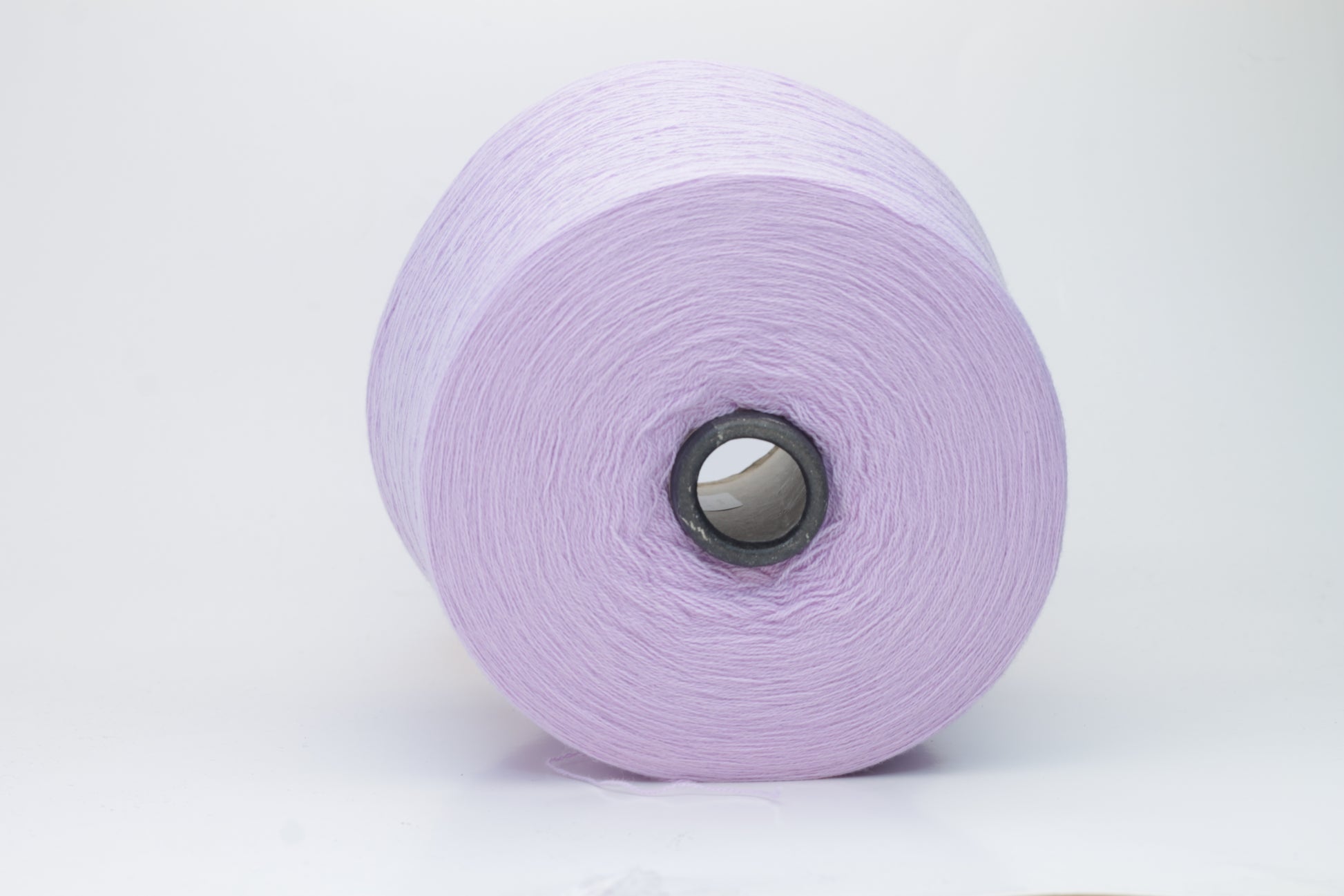Close-up of soft, delicate two-ply cashmere yarn in a serene lavender hue, exhibiting a subtle halo and gentle sheen.