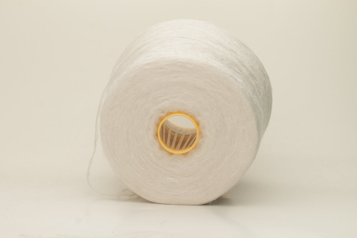 Luxurious, pristine white single-ply silk yarn with a smooth, uniform texture and a delicate sheen, softly coiled.