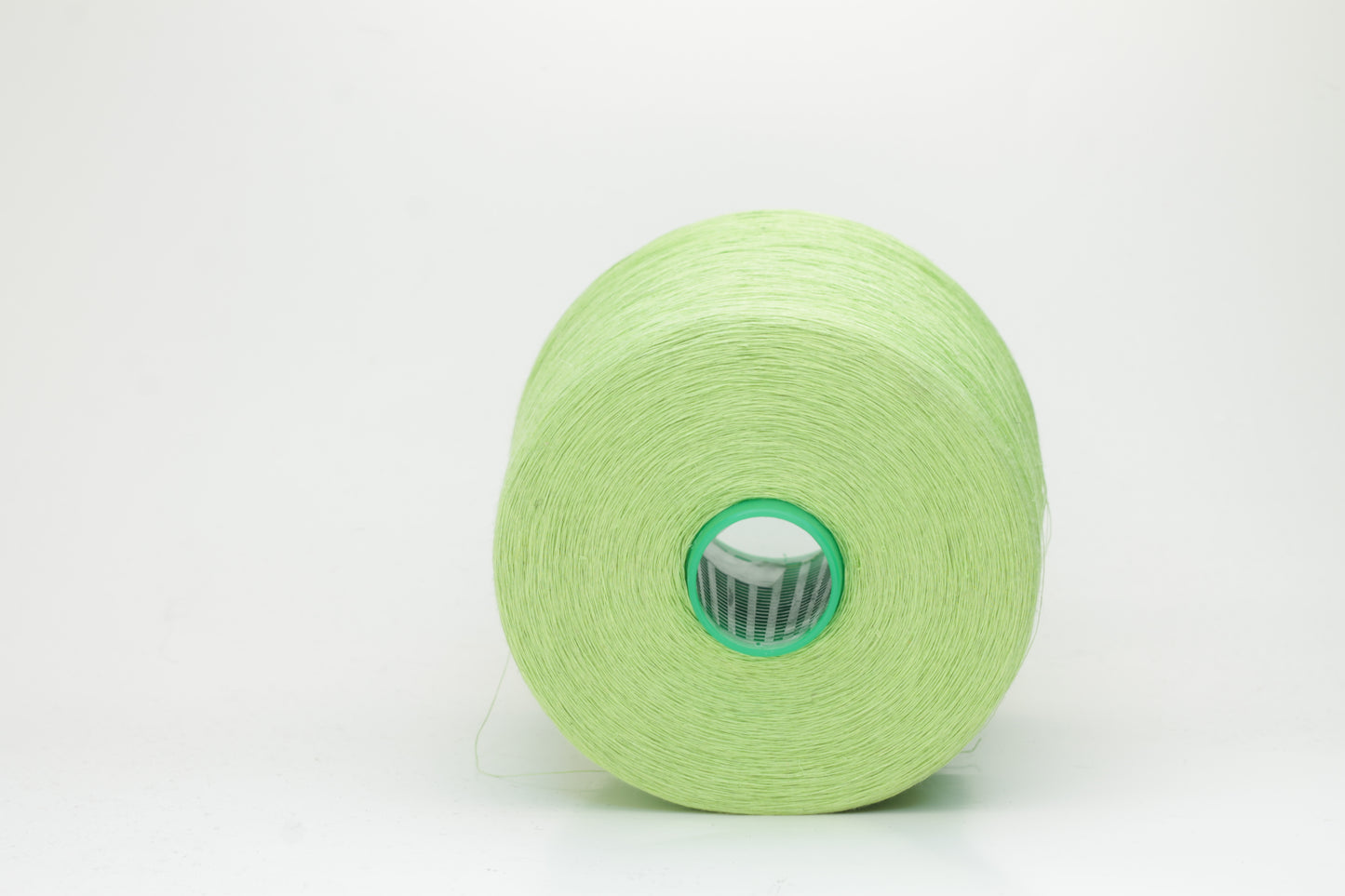 Fine, single-ply linen yarn in a rich Light Apple Green. Reveals a crisp texture and subtle natural sheen, typical of pure linen fiber.