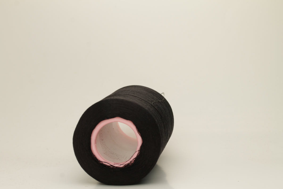 A skein of fine, single-ply 100% silk yarn, lustrous with a deep, rich Black hue, reflecting light softly.
