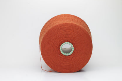 Close-up of luxurious Terra Cotta Merino wool yarn, two-ply twist with a soft, subtle sheen, and fine, consistent thread structure.