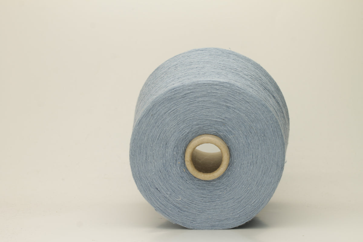 A tightly twisted single strand of luxurious deep royal blue silk yarn, reflecting light with a soft, natural sheen.