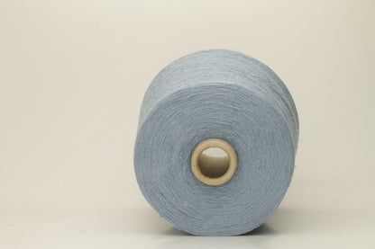 A tightly twisted single strand of luxurious deep royal blue silk yarn, reflecting light with a soft, natural sheen.