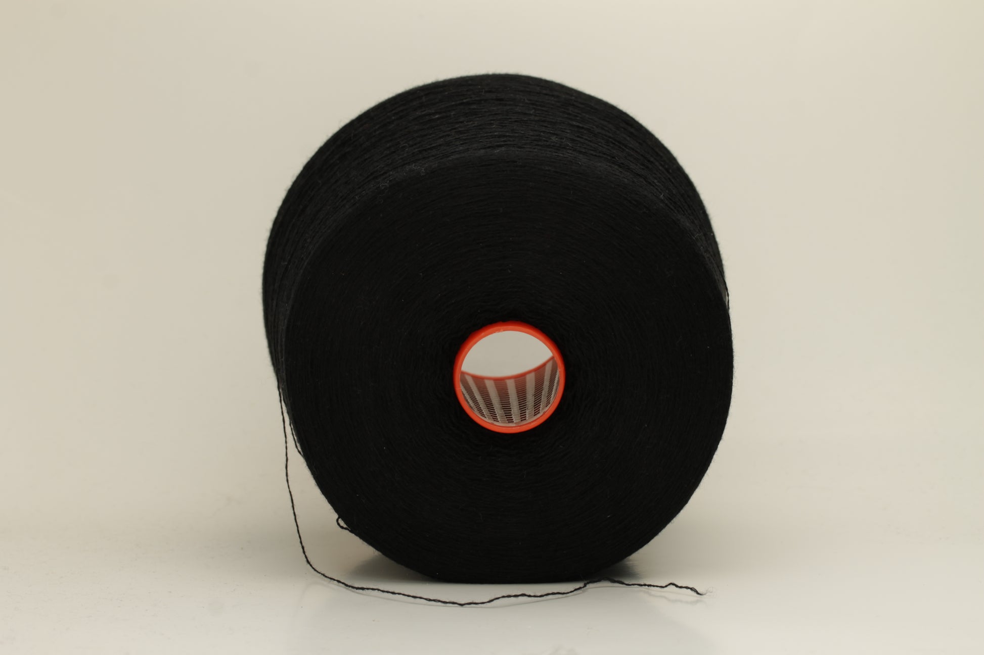 Rich, deep black 2-ply yarn with a fine, smooth twist; exhibits a subtle sheen and incredibly soft, uniform texture.