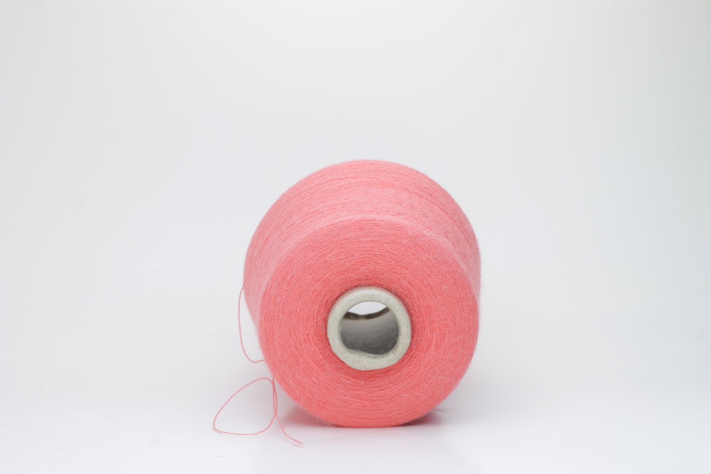 Coral 2-ply Alpaca Merino yarn, softly twisted with a gentle halo and subtle sheen, showcasing its deep, luxurious color saturation.