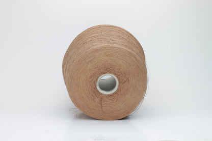 A finely spun, single-ply yarn in an earthy light brown hue, showcasing a delicate, rustic texture and a subtle, natural matte sheen.