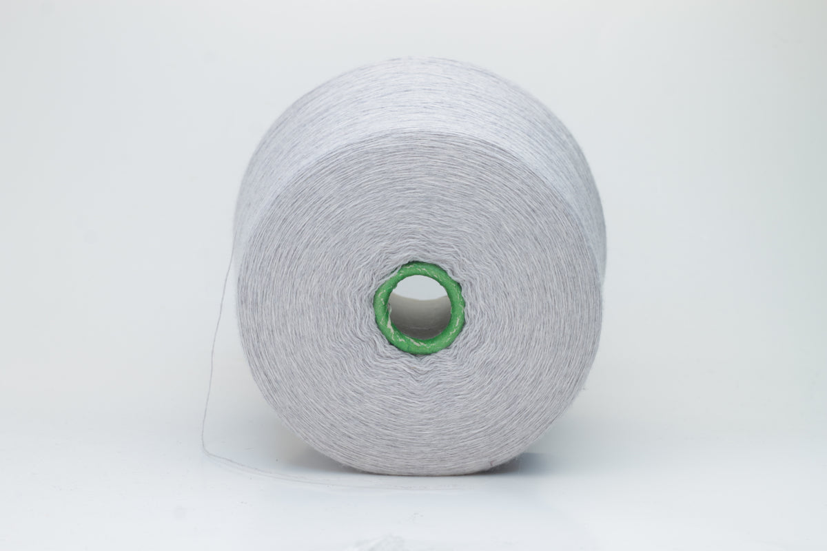 Close-up of a luxurious light blue merino wool yarn skein, showcasing its fine ply twist and subtle sheen, emphasizing the soft fluffiness and vibrant color depth.