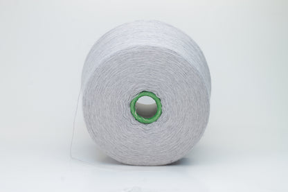 Close-up of a luxurious light blue merino wool yarn skein, showcasing its fine ply twist and subtle sheen, emphasizing the soft fluffiness and vibrant color depth.