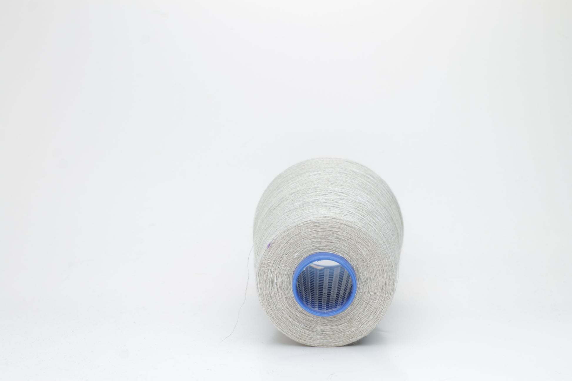 Fine, single-ply linen yarn in a rich Light Gray. Reveals a crisp texture and subtle natural sheen, typical of pure linen fiber.