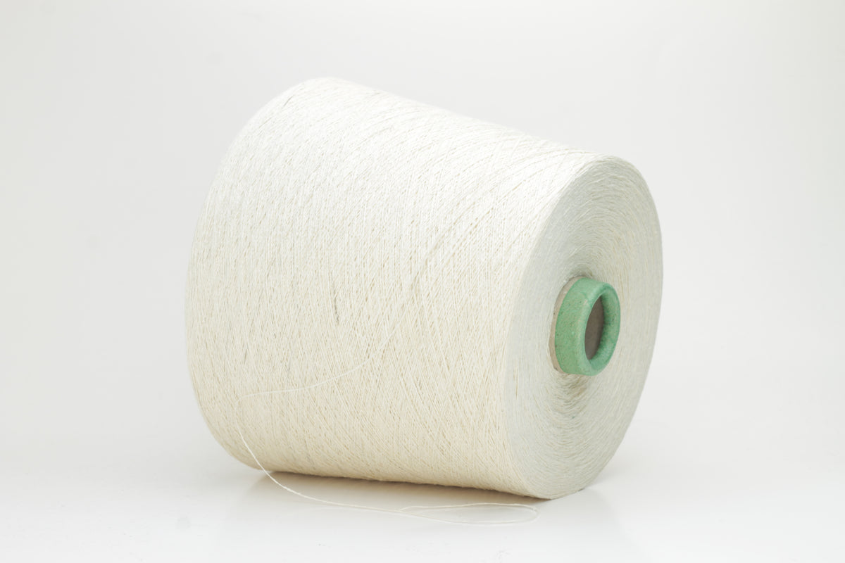 Close-up of a skein of soft, pure white bourette silk yarn with characteristic subtle slubs and a matte, natural finish.