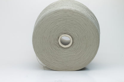 Close-up shot of the grey merino yarn, showcasing its fine 2/30 ply twist and subtle sheen, with a fluffy texture revealed through careful lighting.