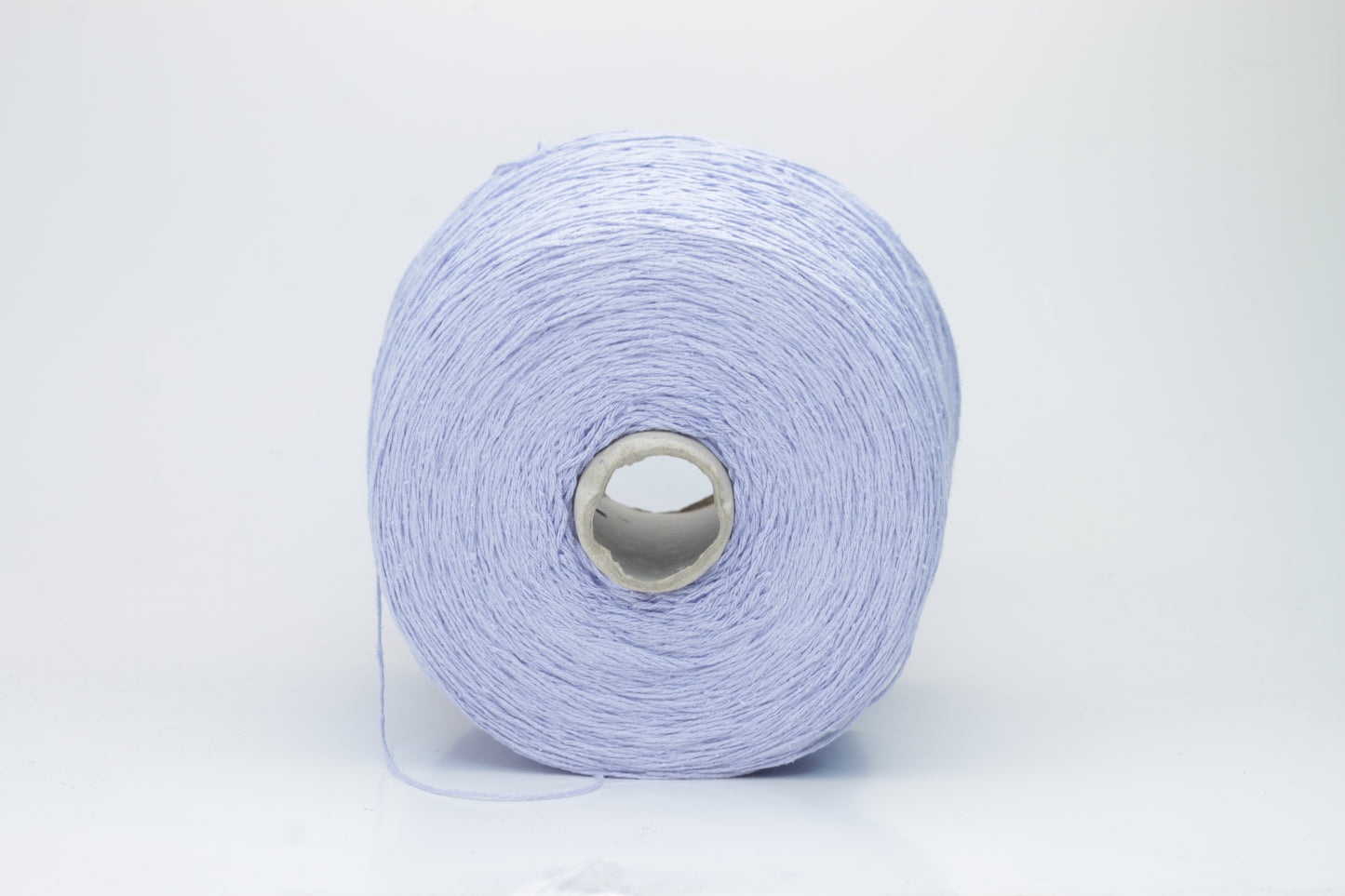 Close-up of a skein of soft, nubby Serenity blue bourette silk yarn. Its matte finish and subtle slubs reveal a raw, natural texture.