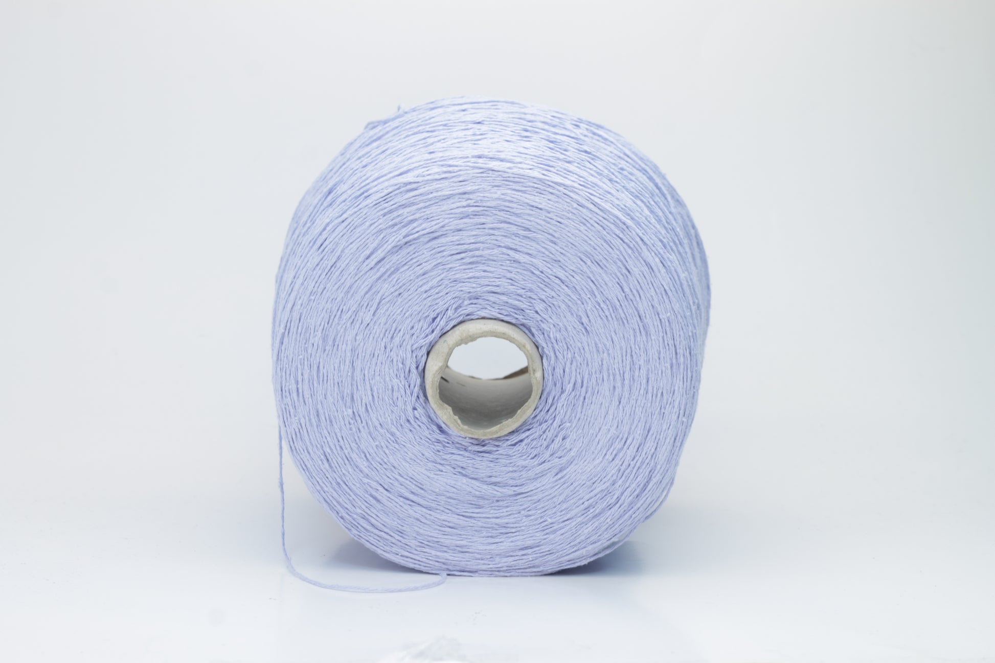 Close-up of a skein of soft, nubby Serenity blue bourette silk yarn. Its matte finish and subtle slubs reveal a raw, natural texture.