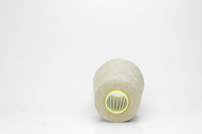 Fine, single-ply linen yarn in a rich Pale Oatmeal. Reveals a crisp texture and subtle natural sheen, typical of pure linen fiber.