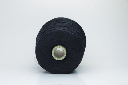 Spool of rich, deep black silk yarn, showcasing its fine, smooth plies and radiant, natural luster against a soft background.