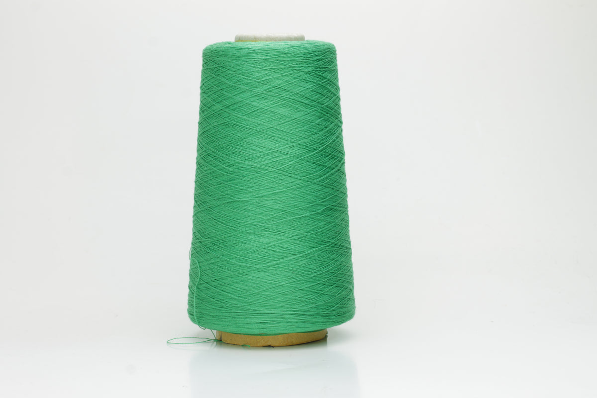 Close-up of a single strand of lustrous, single-ply 100% silk yarn in a vibrant mint green, showcasing its smooth texture and elegant sheen.