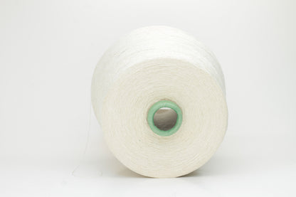 Close-up of a skein of soft, pure white bourette silk yarn with characteristic subtle slubs and a matte, natural finish.